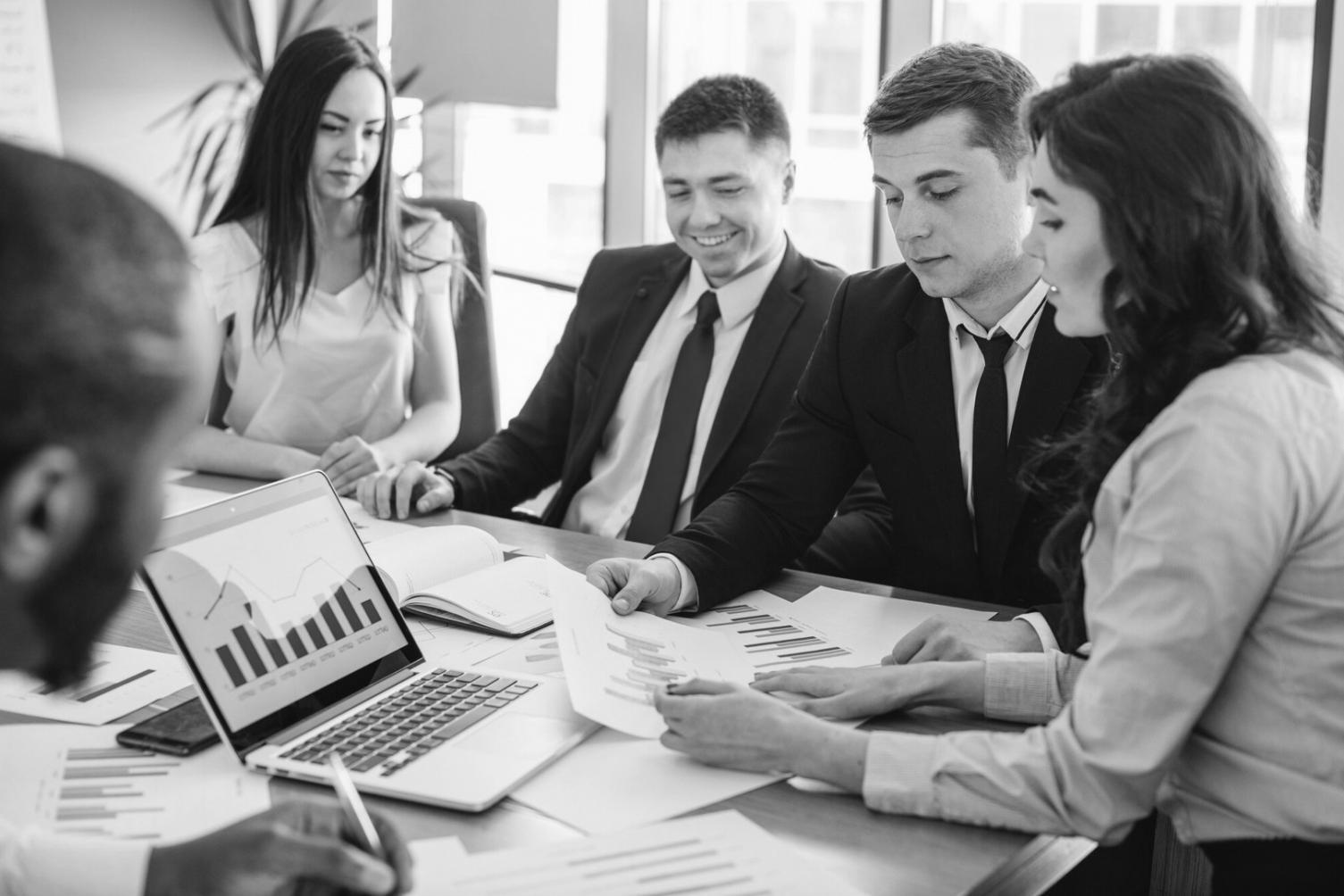 Professional analyzing financial charts and budget trends on multiple screens showing data visualization and spending patterns